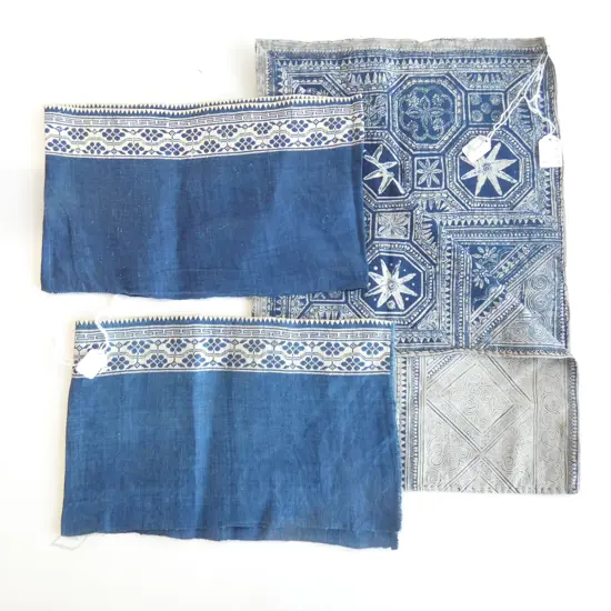 A pair of indigo dyed cotton cuffs plus a piece of wax resist cloth.